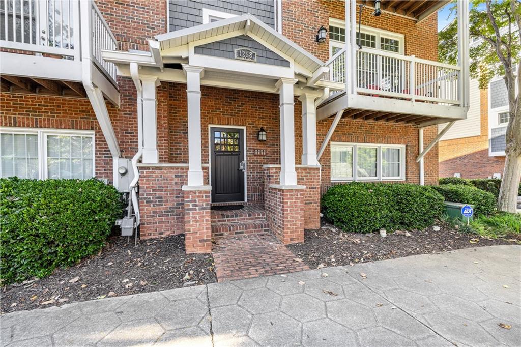 1258 DeKalb Avenue Northeast, Unit 135 Atlanta, GA 30307 - Photo 5 of 45 a view of a brick house with many windows next to a road