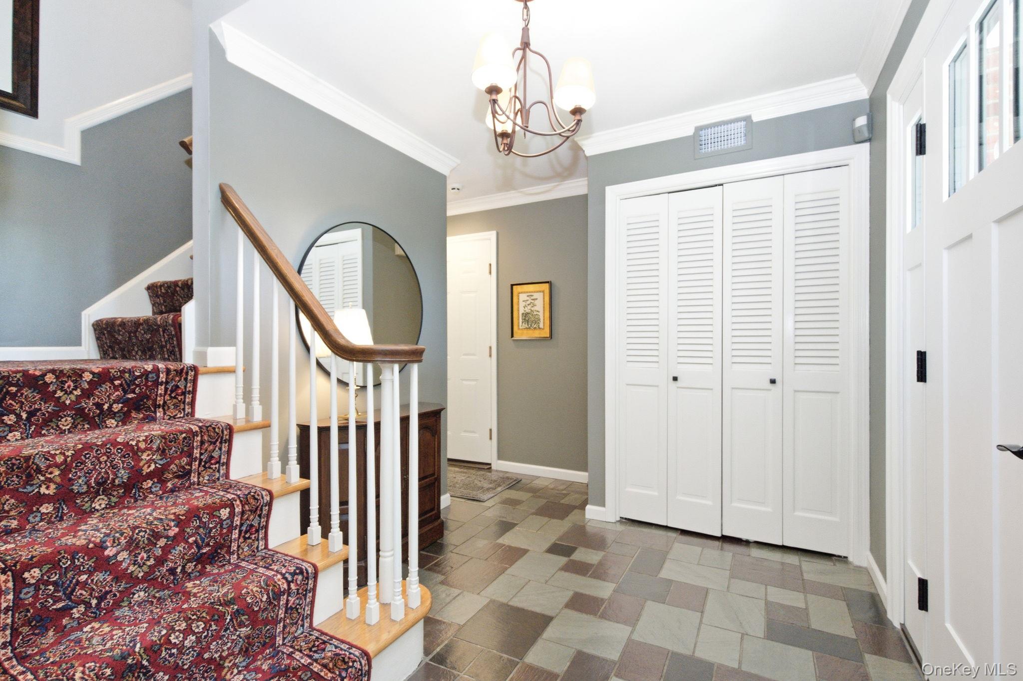 32 Bedell Road Katonah, NY 10536 - Photo 4 of 49 Classic millwork, crown molding, and a roomy closet distinguish the gracious front hall.