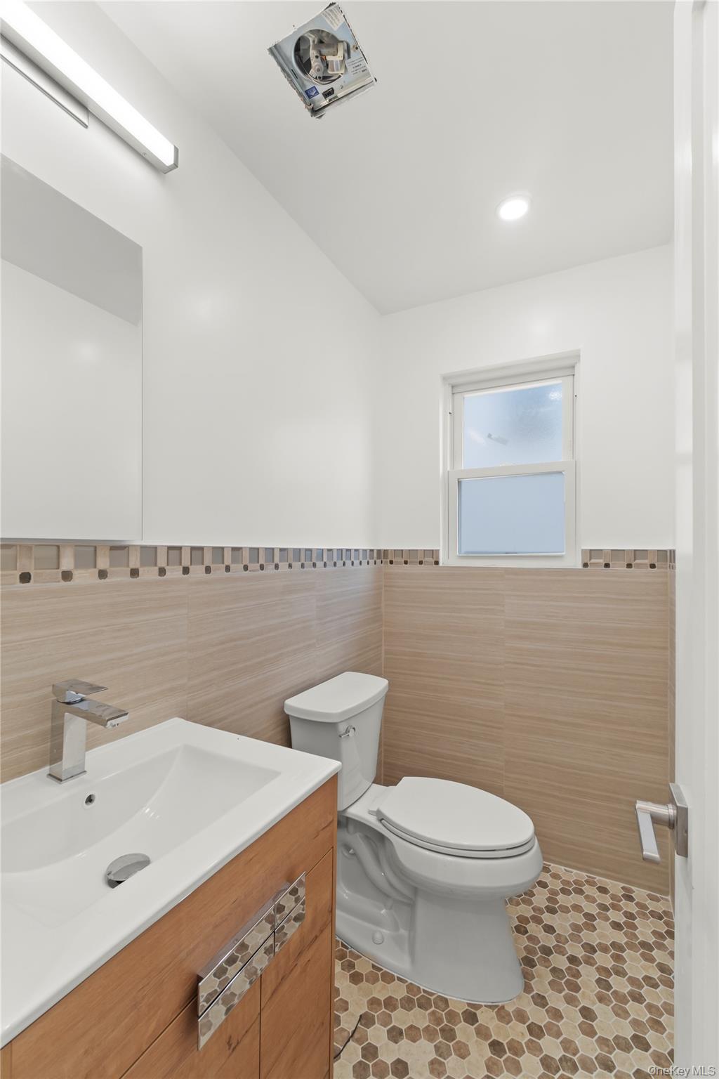 249-09 Mayda Road Queens, NY 11422 - Photo 19 of 28 a bathroom with a toilet a sink and mirror
