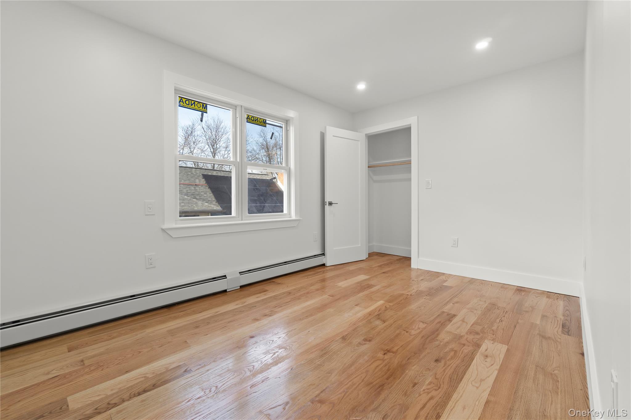 249-09 Mayda Road Queens, NY 11422 - Photo 23 of 28 an empty room with wooden floor and windows