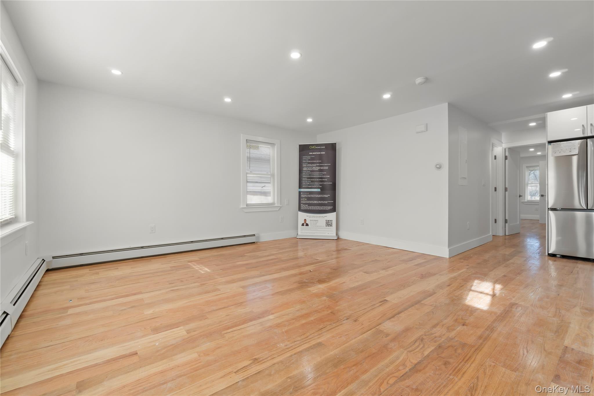 249-09 Mayda Road Queens, NY 11422 - Photo 4 of 28 a view of an empty room with wooden floor and a window