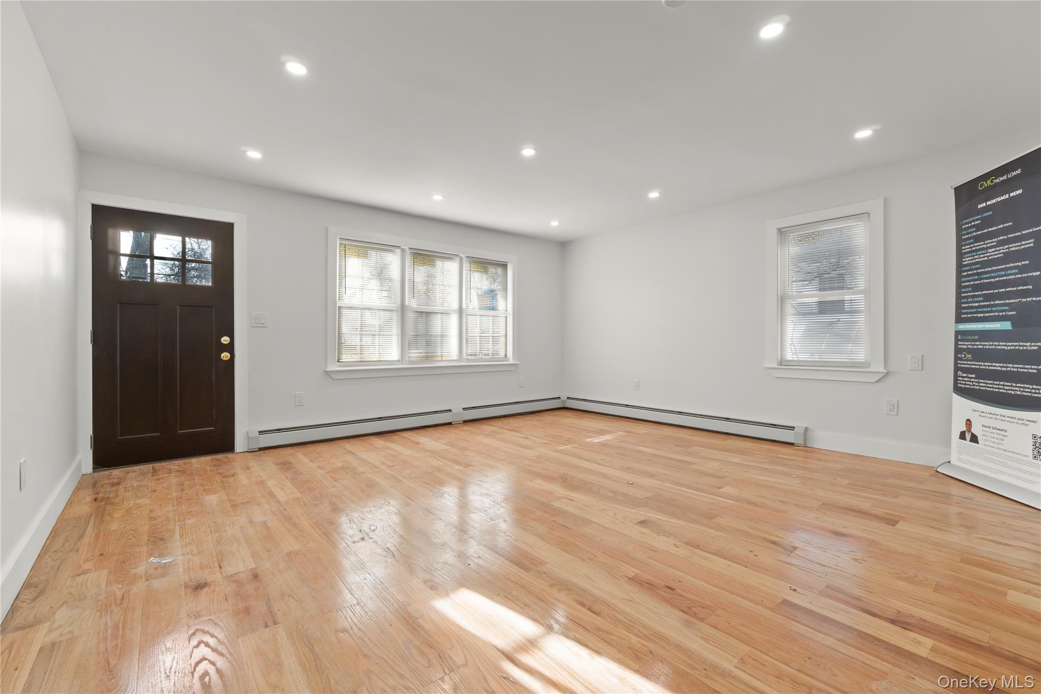 249-09 Mayda Road Queens, NY 11422 - Photo 5 of 28 a view of an empty room with wooden floor and a window