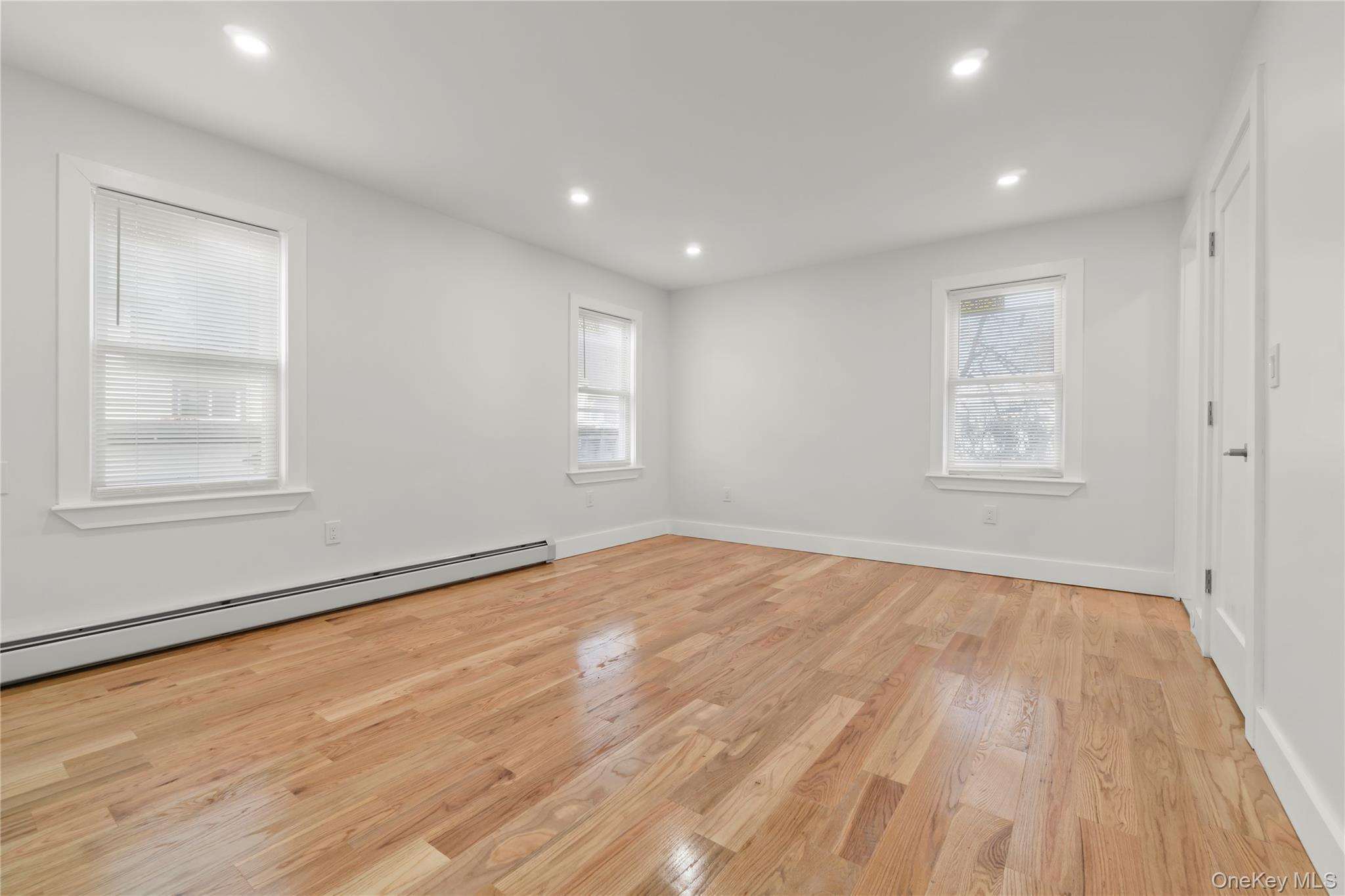 249-09 Mayda Road Queens, NY 11422 - Photo 8 of 28 a view of empty room with wooden floor and fan