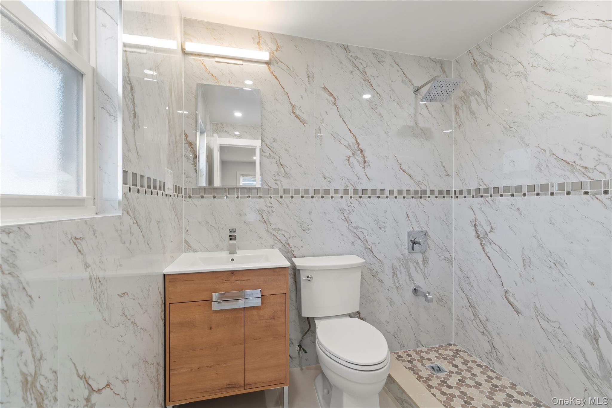 249-09 Mayda Road Queens, NY 11422 - Photo 9 of 28 a bathroom with a sink a toilet and shower