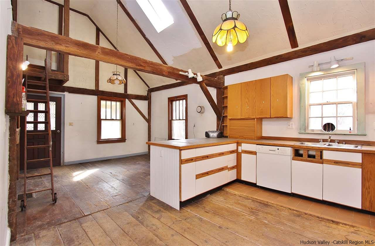 32 Barberry Road Kingston, NY 12401 - Photo 9 of 31 a large white kitchen with a large window a sink and stainless steel appliances