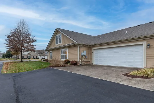 a view of a house with a yard and garage