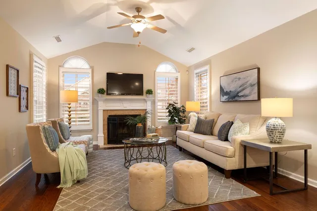 a living room with furniture a flat screen tv and a fireplace