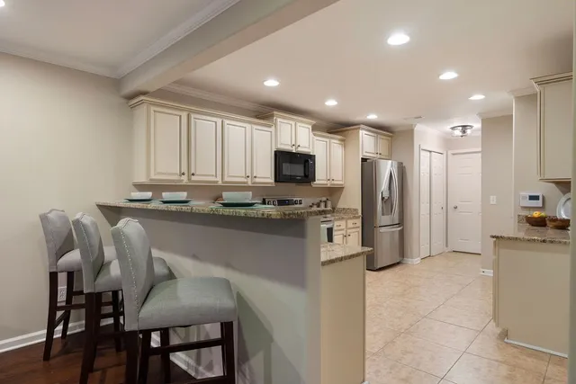 a kitchen with stainless steel appliances a refrigerator sink microwave and cabinets