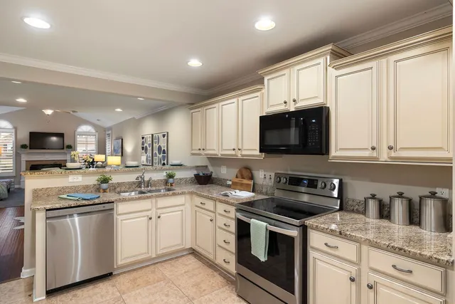 a kitchen with a sink stove top oven and cabinets