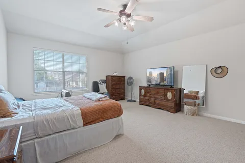 a bedroom with bed and window