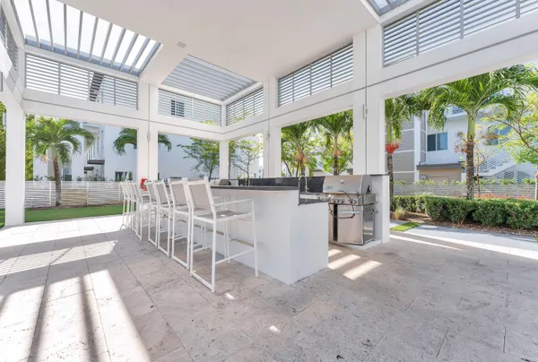 a view of swimming pool with palm trees