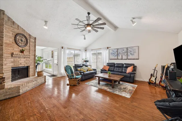 a living room with furniture a fireplace and a flat screen tv