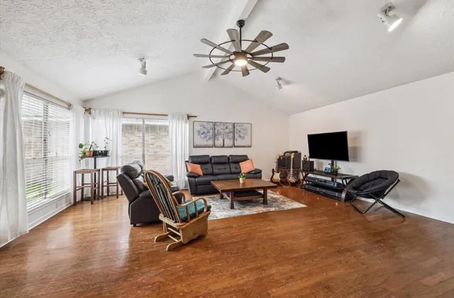 a living room with furniture and a flat screen tv