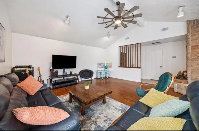 a living room with furniture and a flat screen tv
