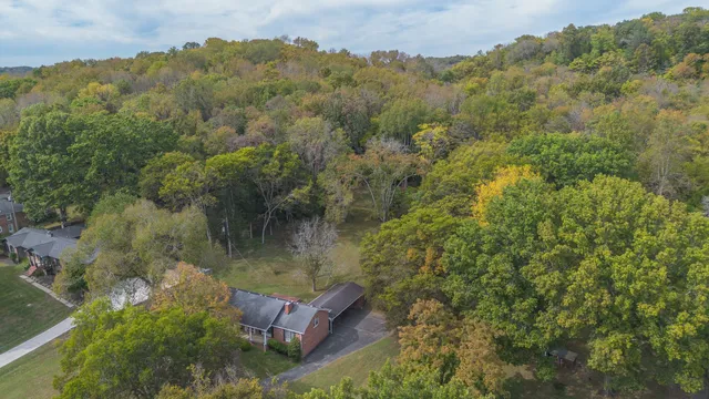 a large kitchen with a wooden floor and cabinets