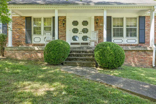 a front view of a house with garden
