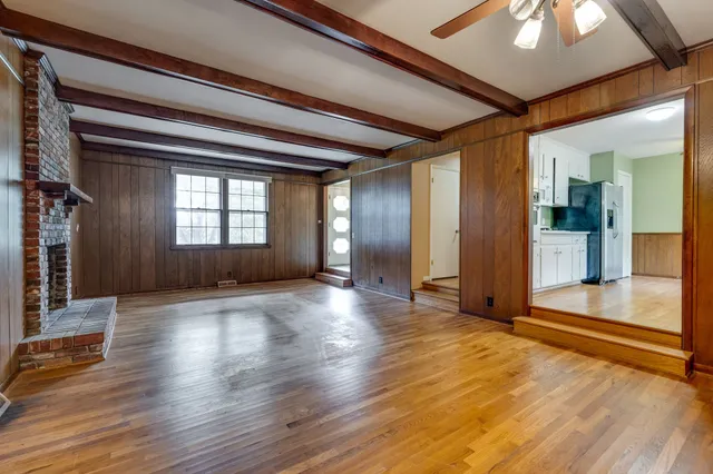 a bathroom with a granite countertop sink a mirror and shower