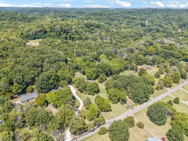 a bathroom with a granite countertop sink a mirror and shower