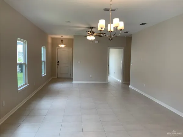 a view of a chandelier fan and entryway