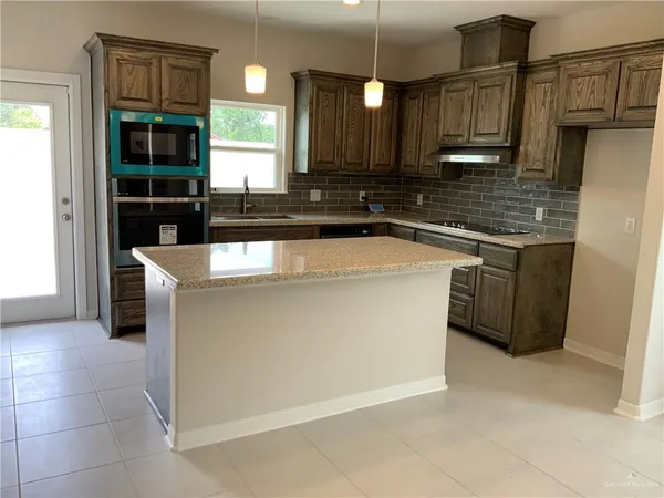 a view of a kitchen and a window in the room