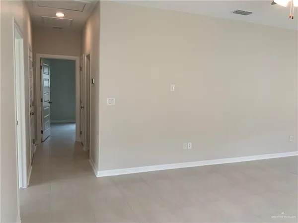 a view of a kitchen with a sink and refrigerator