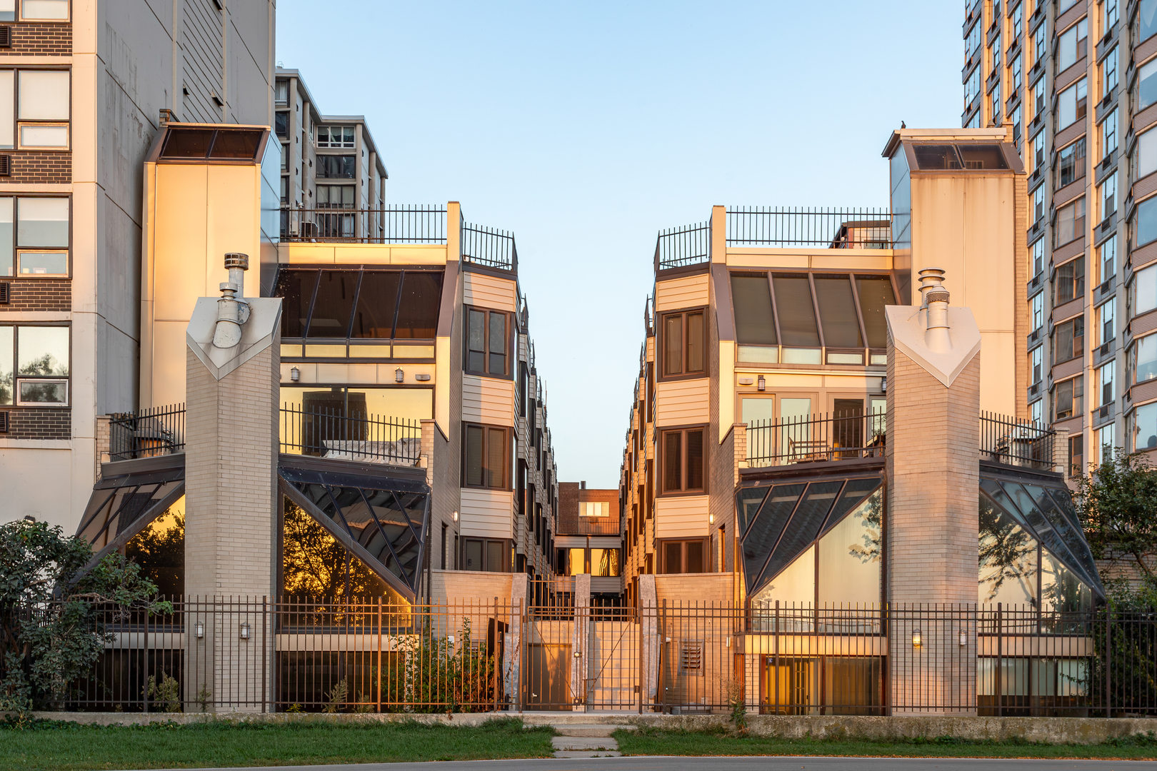 a front view of a residential apartment building with a yard