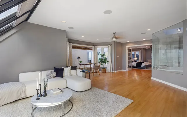 a living room with furniture and a wooden floor
