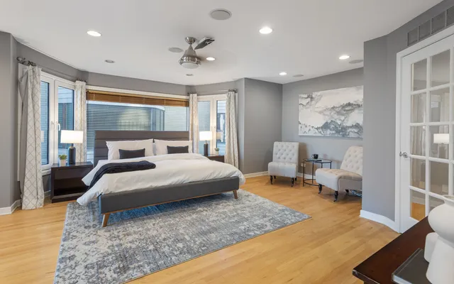 a bedroom with a large bed and a chandelier