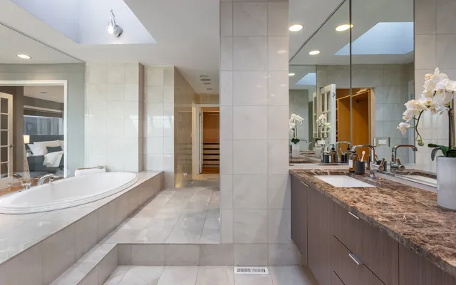 a bathroom with a glass shower door and a sink