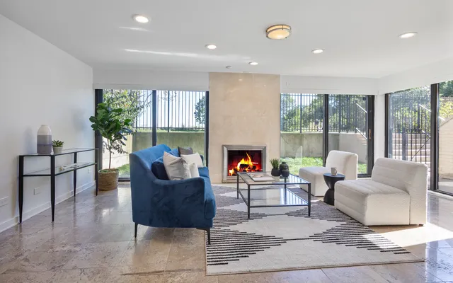 a view of a hallway with furniture and a livingroom