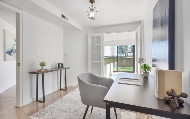 a living room with furniture and a chandelier