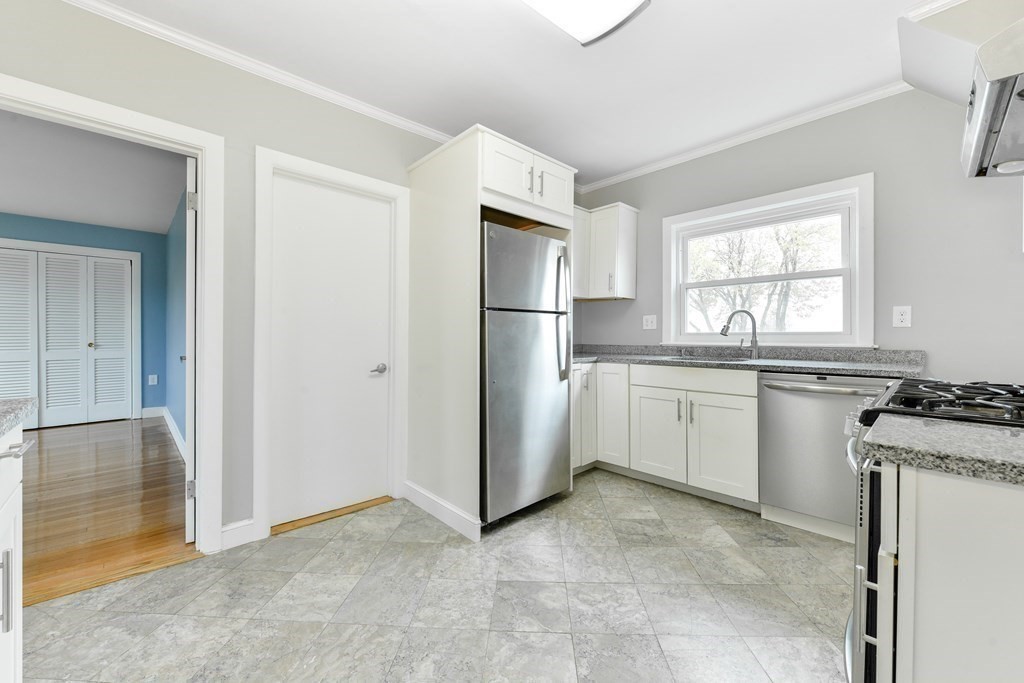 40 Bosson Street, Unit 2 Revere, MA 02151 - Photo 2 of 13 a kitchen with white cabinets and white appliances
