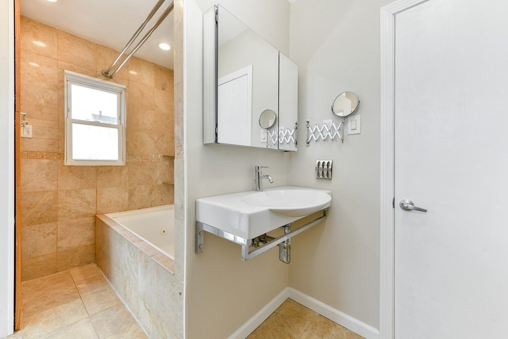 40 Bosson Street, Unit 2 Revere, MA 02151 - Photo 6 of 13 a bathroom with a sink and a mirror