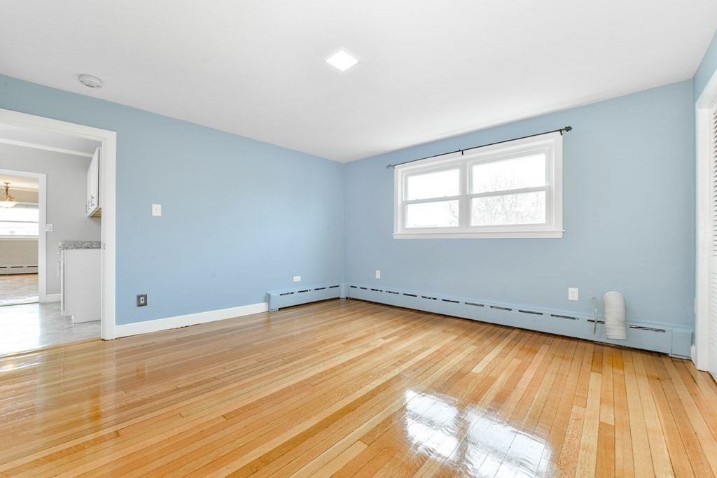 40 Bosson Street, Unit 2 Revere, MA 02151 - Photo 7 of 13 an empty room with wooden floor and windows