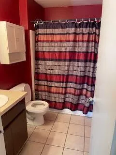 an empty room with a fan & a ceiling fan