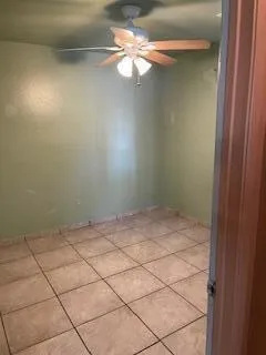 a view of a hallway with a chandelier fan and a livingroom