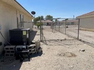 a view of a chairs and table in backyard