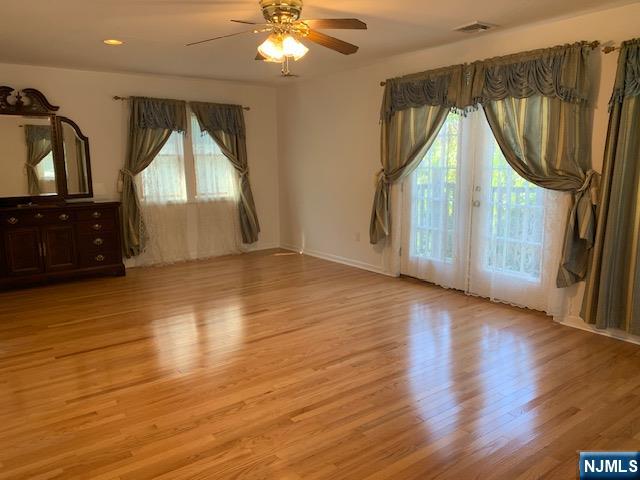 279 Slocum Way Fort Lee, NJ 07024 - Photo 11 of 20 a view of empty room with wooden floor and fan