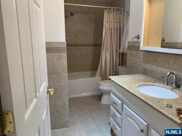 279 Slocum Way Fort Lee, NJ 07024 - Photo 12 of 20 a bathroom with a granite countertop sink a toilet and shower