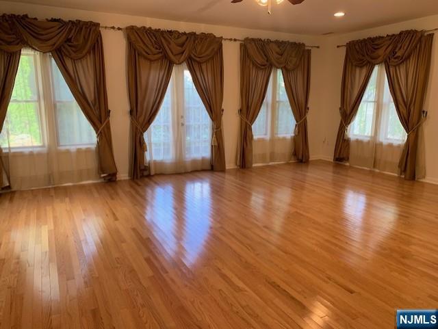 279 Slocum Way Fort Lee, NJ 07024 - Photo 9 of 20 a view of empty room with wooden floor and fan