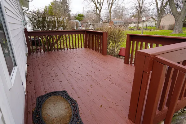a view of a wooden deck and a yard