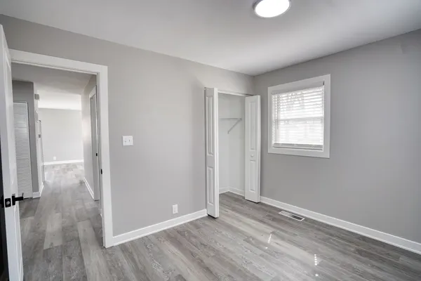 a view of an empty room and wooden floor