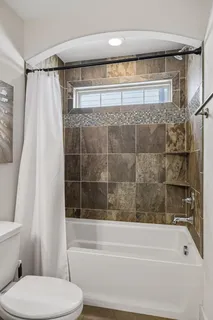 a bathroom with a shower and a toilet