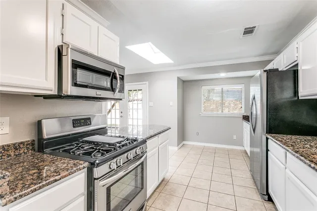 a kitchen with a sink stove top oven and cabinets