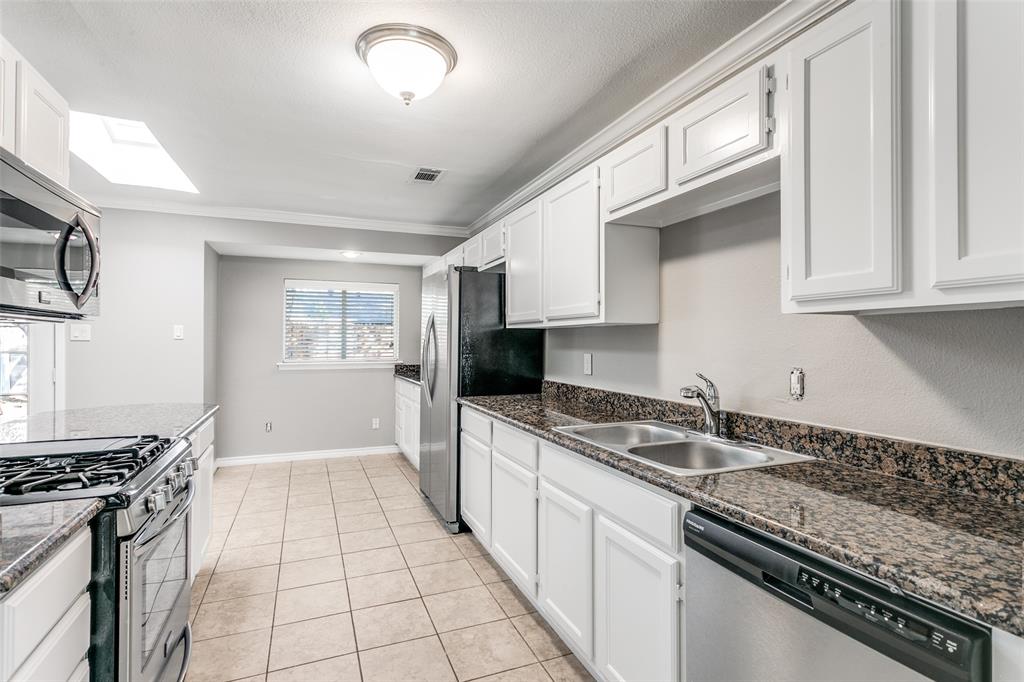845 Lovers Lane Grapevine, TX 76051 - Photo 11 of 24 a kitchen with a sink stove top oven and cabinets