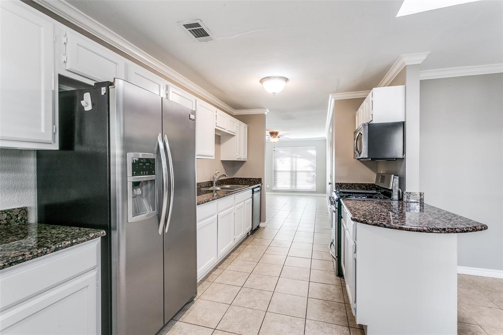 845 Lovers Lane Grapevine, TX 76051 - Photo 12 of 24 a large kitchen with a large counter top stainless steel appliances and cabinets
