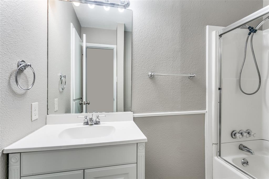 845 Lovers Lane Grapevine, TX 76051 - Photo 17 of 24 a bathroom with a sink a mirror and a shower