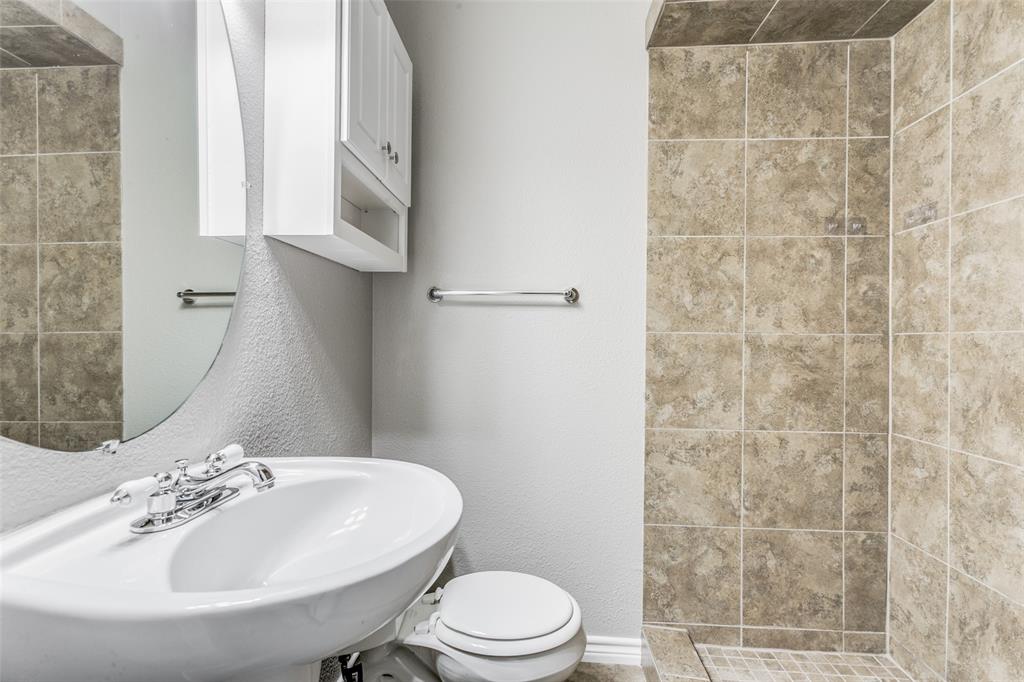 845 Lovers Lane Grapevine, TX 76051 - Photo 20 of 24 a bathroom with a sink a toilet and shower