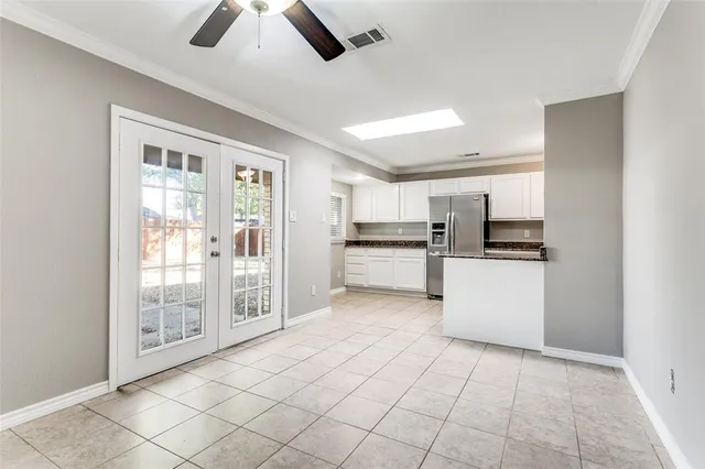 a kitchen with stainless steel appliances kitchen island granite countertop a refrigerator and a sink