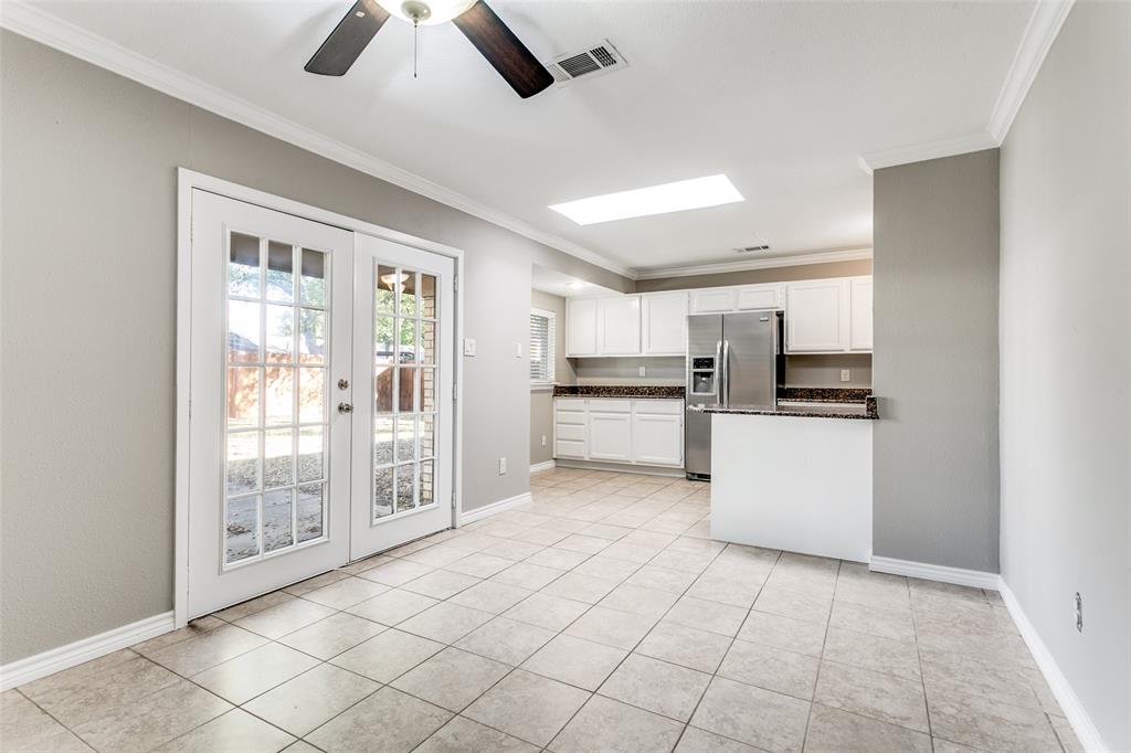 845 Lovers Lane Grapevine, TX 76051 - Photo 7 of 24 a kitchen with stainless steel appliances kitchen island granite countertop a refrigerator and a sink